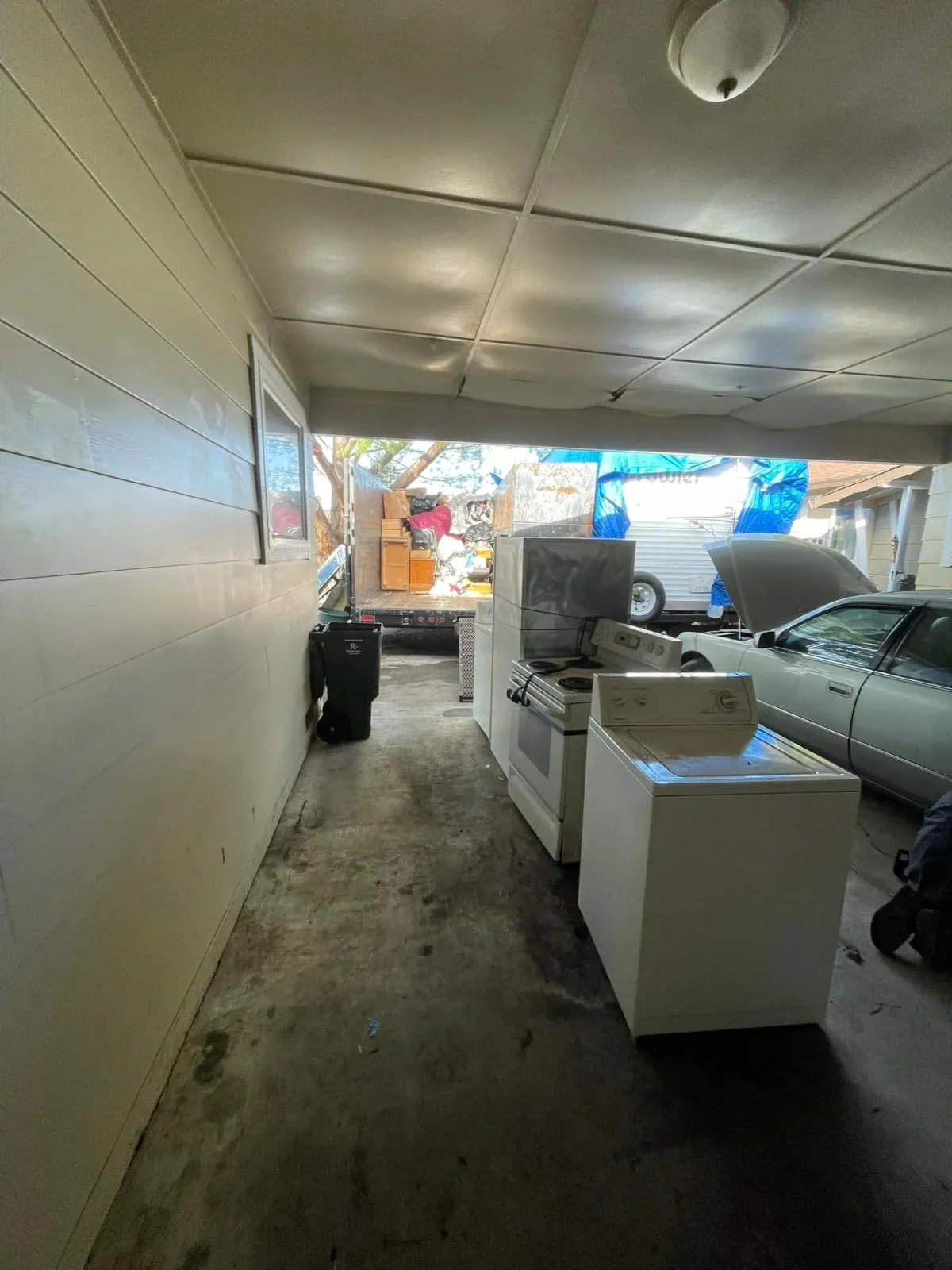A washing machine, range and refrigerator in a carport